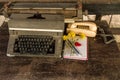 Vintage typewriter , old telephone , dry chrysanthemum flower and white paper note old wooden touch-up in still life concept Royalty Free Stock Photo