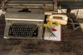 Vintage typewriter , old telephone , dry chrysanthemum flower and white paper note old wooden touch-up in still life concept Royalty Free Stock Photo