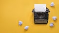 Vintage typewriter over yellow background with copy space Royalty Free Stock Photo