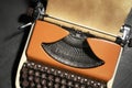 Vintage typewriter with parchment paper on black background, top view Royalty Free Stock Photo