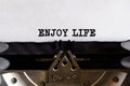 Vintage typewriter with printed text - ENJOY LIFE, on a sheet of paper Royalty Free Stock Photo