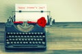 Vintage typewriter with red rose flower. Happy Womens Day Royalty Free Stock Photo