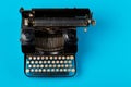 Vintage typewriter top down flatlay shot from above on cyan Royalty Free Stock Photo