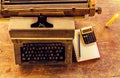 Vintage typewriter ,white  book, calculator ,pencil and candlelight on old wooden touch-up in still life concept Royalty Free Stock Photo