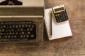 Vintage typewriter ,white  book, calculator ,pencil and candlelight on old wooden touch-up in still life concept Royalty Free Stock Photo