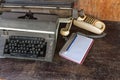 Vintage typewriter ,white  book,  ,pencil and old telephone on old wooden touch-up in still life concept Royalty Free Stock Photo