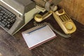 Vintage typewriter ,white  book,  ,pencil and old telephone on old wooden touch-up in still life concept Royalty Free Stock Photo