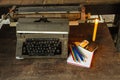 Vintage typewriter ,white  book, pencils and candlelight on old wooden touch-up in still life concept Royalty Free Stock Photo