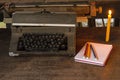 Vintage typewriter ,white  book, pencils and candlelight on old wooden touch-up in still life concept Royalty Free Stock Photo