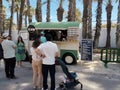 A vintage typical American food truck and people customers during the traditional Street Food Market festival. Royalty Free Stock Photo