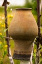 Vintage ukrainian clay jug hanging on the tree