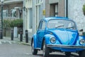 Vintage ultramarine blue classic car on city parking outdoors