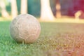 vintage used soccer ball lying on the grass in park, in the shadow. Trees in the background are in the sun, Rio de Janeiro. Colore Royalty Free Stock Photo