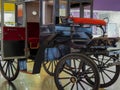 Vintage vehicle carriage caretaker abandoned emperor comfort wheel spokes tree metal road fan Royalty Free Stock Photo