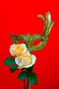 Vintage venetian masquerade mask with peach roses on red backdrop