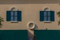 Vintage Venice window with colorful wall background. Grungy vivid wall with blue windows background.