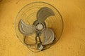 vintage ventilator on yellow concrete wall