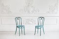 Vintage viennese chairs against the wall with a bas-relief of plaster stucco. Selective focus Royalty Free Stock Photo