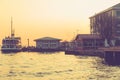 Vintage view from Istanbul city with passenger ship, port and seagulls at sunset background