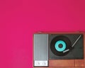 Vintage vinyl player and turnable on a fuchsia background