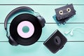 Vintage vinyl record, headphones, earphones, cassette player and cassettes on wooden table Royalty Free Stock Photo