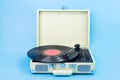Vintage vinyl record player isolated on blue background. Royalty Free Stock Photo