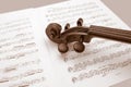 Vintage violin resting over music scores