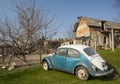 Vintage volkswagen beetle car rusting in the backyard in a villa Royalty Free Stock Photo