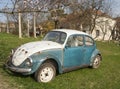 Vintage volkswagen beetle car rusting in the backyard in a villa Royalty Free Stock Photo