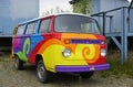 A vintage Volkswagen (VW) camper van painted with psychedelic hippy colors