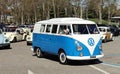 Vintage VW Transporter Type 2 with some Beetle cars on behind during a Volkswagen classic car parade. Royalty Free Stock Photo