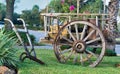 Vintage wagon cart and horse plow displayed on a lawn.