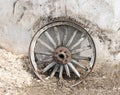 Vintage wagon wheel against an adobe wall Royalty Free Stock Photo