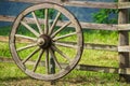 Vintage wagon wheel on old wooden fence Royalty Free Stock Photo