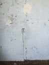 Vintage wall socket on cracked blue wall