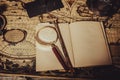 Vintage wallpaper with copy space. Antique desk with an open book with magnifying glass and tenebrous light.