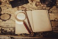 Vintage wallpaper with copy space. Antique desk with an open book with magnifying glass and tenebrous light.