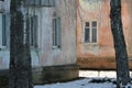 Vintage walls of old houses with windows and with the texture of old painted peeling plaster. Grunge background of urban decay Royalty Free Stock Photo