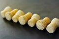 Diagonally lined seven sparkling wine corks on black background.