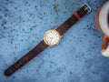 Gold/silver vintage watch with brown leather bracelet.