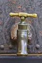 Vintage water tap on an old industrial tank. Royalty Free Stock Photo