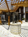 Vintage water well with view of CioccolatItaliani cafe in Kalaja e Tiranes market. Tirana, Albania