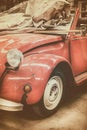 Vintage weathered classic red car in an old garage