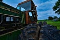 Vintage weathered and rusty Oliver tractor with oversize worn tires in a field