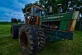 Vintage weathered and rusty Oliver tractor with oversize worn tires in a field
