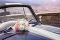 Vintage Wedding Car With Bouquet Of Flowers On Bonnet
