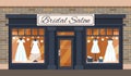 Vintage wedding shop store facade with large window, columns, brick wall