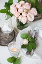 Vintage wedding table decorations with roses, candles cutlery Royalty Free Stock Photo