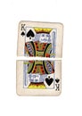 A vintage king of spades playing card torn in half. Royalty Free Stock Photo