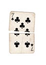 A vintage seven of clubs playing card torn in half.